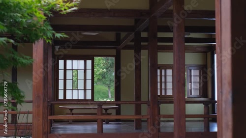 Traditional japanese wooden pavilion in a peaceful green garden