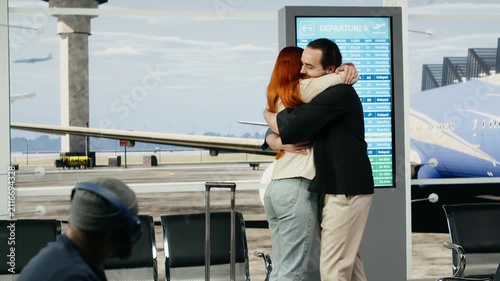 A young couple reunites in an airport terminal after a long-distance relationship, hugging with joy on arrival and sharing an emotional moment.