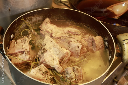Pork pieces simmering before traditional Peruvian chicharrón preparation