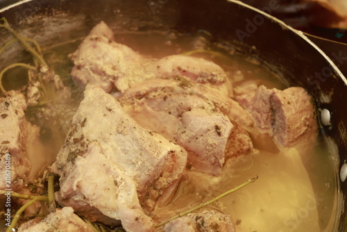 Pork pieces simmering before traditional Peruvian chicharrón preparation