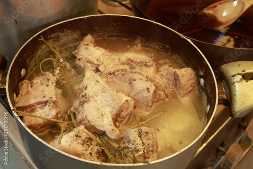 Pork pieces simmering before traditional Peruvian chicharrón preparation