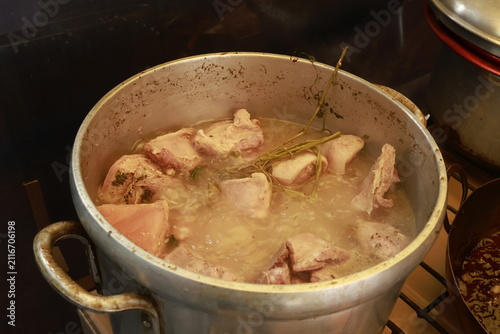 Pork pieces simmering before traditional Peruvian chicharrón preparation