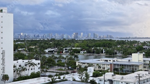 Obraz na plátne Miami Waterfront Skyline Under Stormy Clouds – Tropical Cityscape View