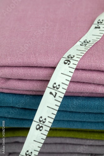 Measuring Tape on Folded Linen Fabric in Pastel Colors