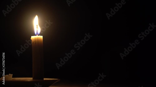 Single Candle Burning and Waving in the Dark with Copy Space