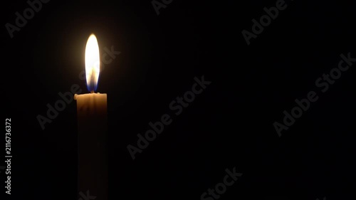 Single Candle Burning and Waving in the Dark with Copy Space