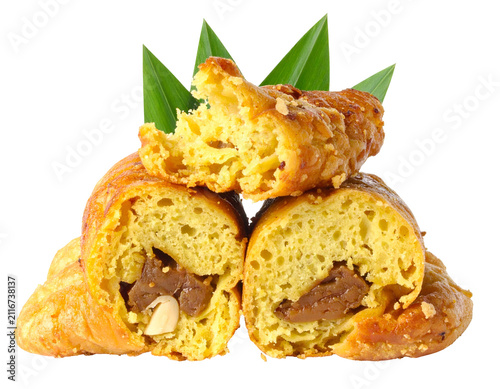 Delicious fried banana fritters with chocolate filling and pandan leaves garnish