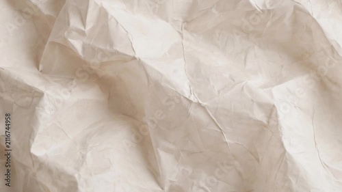 A high-resolution close-up of off-white paper featuring intricate creases, folds, and organic wrinkles. The soft natural lighting creates gentle shadows and highlights, perfect for minimalist design