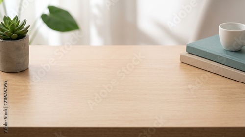 A clean, organized wooden table with open space, featuring a small potted succulent, two books, and a cup of coffee.