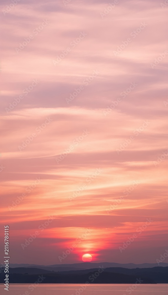 Fototapeta premium Sunset over distant mountains with colorful sky