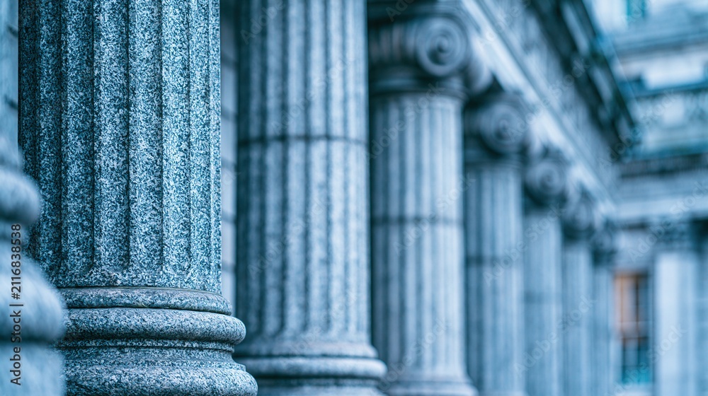 Fototapeta premium Close-up view of classic stone architectural columns in a row, symbolizing justice and tradition