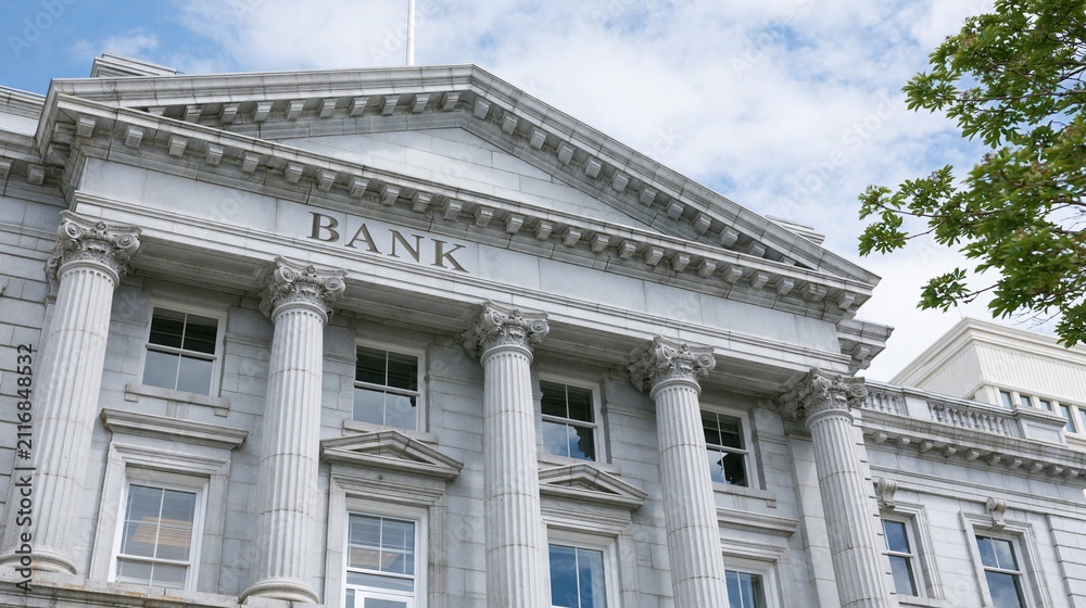 Fototapeta premium Grand Marble Bank Building Facade with Classical Columns and Clear Sky