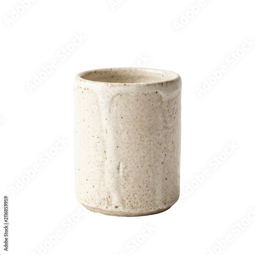 Handmade rustic ceramic cup with speckled glaze on white background.
