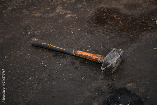 Foto Hammer, specifically a heavy-duty sledgehammer  featuring a robust metal head designed for demolition or forging work