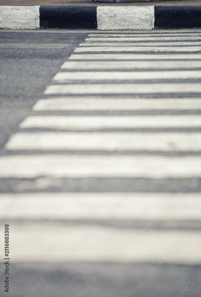 Obraz premium Abstract view of a pedestrian crossing with black and white stripes on asphalt