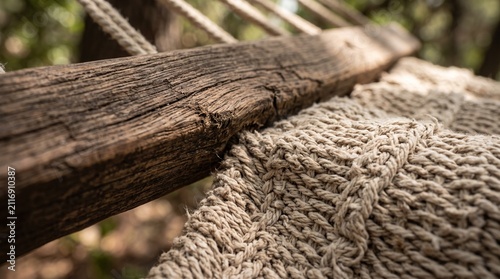 Close-up of a rustic wooden beam and woven net texture in natural light.