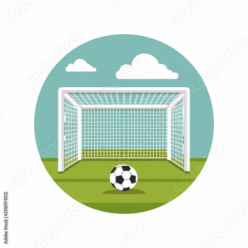 Soccer goal and ball on green field under blue sky with clouds.