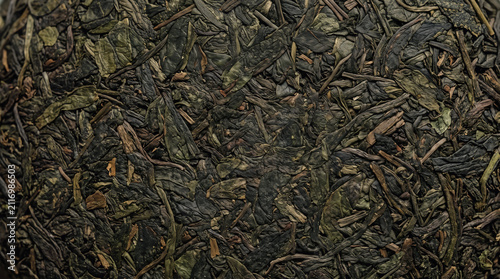 Dried green tea leaves texture. Organic herbal tea background for healthy food design.