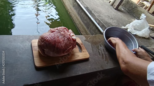 Professional Video Footage of Butcher Carefully Cutting Fresh Raw Meat on a Wooden Cutting Board for Culinary Preparation and Food Industry Concept