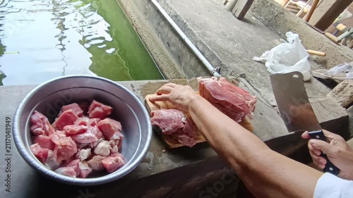 Professional Video Footage of Butcher Carefully Cutting Fresh Raw Meat on a Wooden Cutting Board for Culinary Preparation and Food Industry Concept