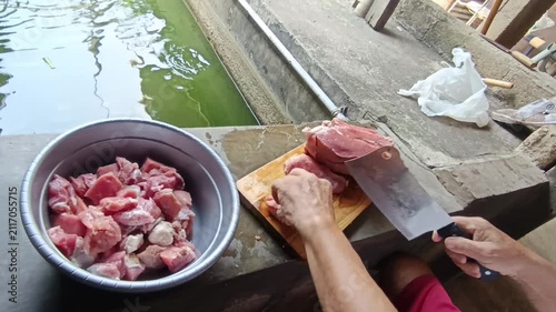 Professional Video Footage of Butcher Carefully Cutting Fresh Raw Meat on a Wooden Cutting Board for Culinary Preparation and Food Industry Concept