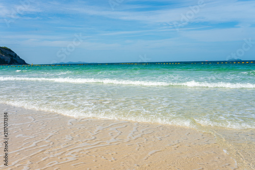 White sand beach wave sea background blue sky with fuffy cloud