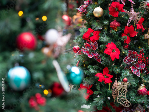 Colorful christmas deco hanging on tree. Holiday or festive concept.