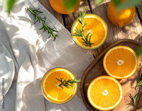 Top view fresh orange rosemary infused water with orange slices