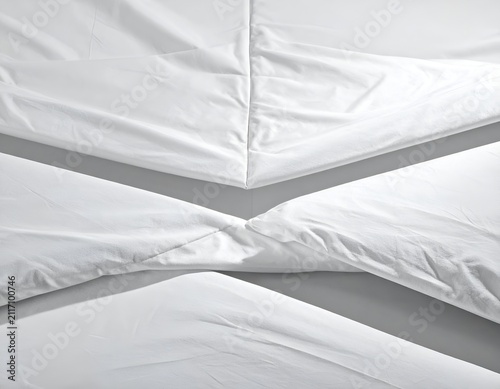 White Cotton Bed Sheets Folded in Geometric Patterns Close Up Studio View
