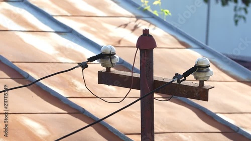 Old Wooden utility pole supplying Electricity to a rural house. 4 k video