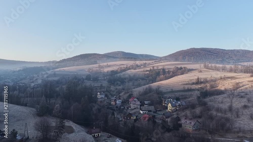 Mountain village in a winter morning mist