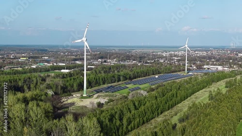 Renewable power plant featuring solar panel farm and wind turbine