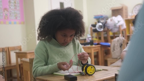 The children are conducting experiments with electric motors.