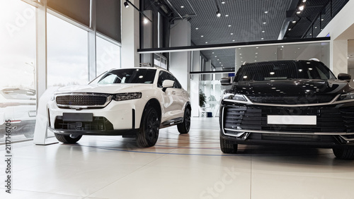 Bild auf Leinwand Cars are displayed in a modern showroom for customers to view and consider for p
