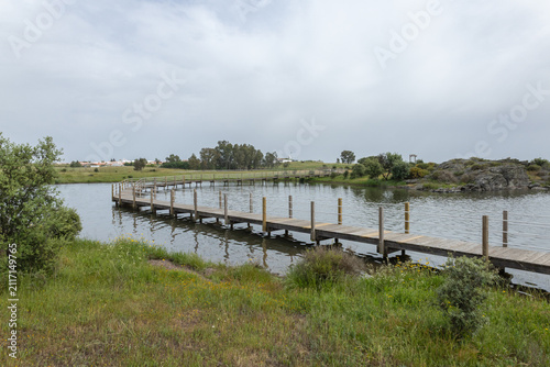 Foto Alentejo boardwalk extending over water in rural landscape