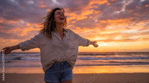Young woman facing ocean sunset rejoices, laughs, smiles looking up to the sky, enjoys life and summer, nature, happiness.
