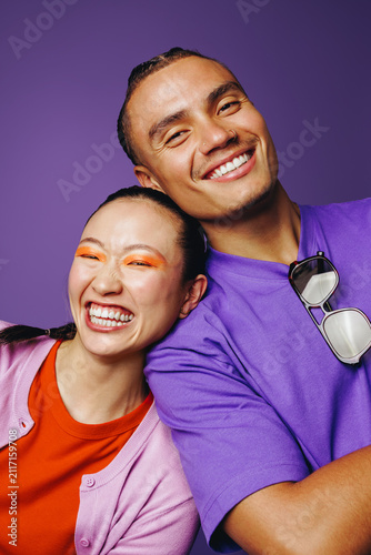 Young friends smile together in a colorful headshot portrait with beauty and joy