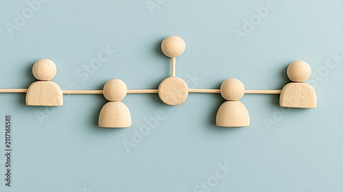 Wooden figures connected by lines on a soft blue background. Concept for team networking, hierarchy and human.