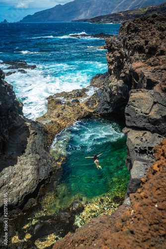 Woman swimming natural pool el hierro canary islands