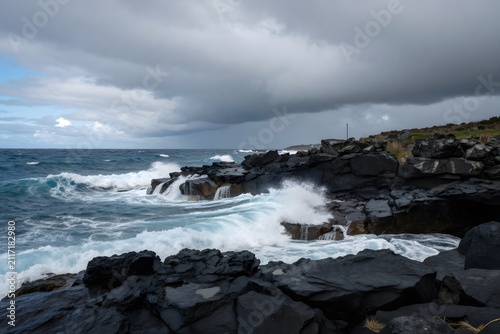 Rocky coastline with ocean waves and dramatic clouds