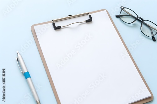 Medical clipboard with blank patient chart and healthcare accessories