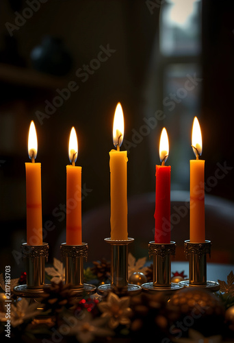 Five lit advent candles in ...