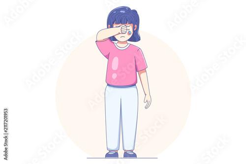 Sad young girl wiping tears from her eyes while crying, expressing emotional distress and childhood sadness