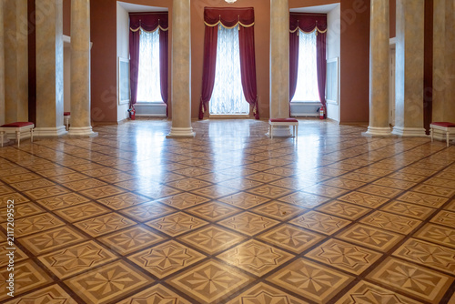 Geometric wooden parquet floor in a classical luxury hall