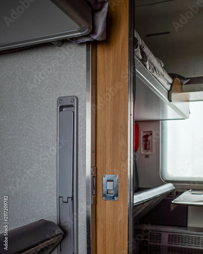Interior of a train compartment with a folded seat.