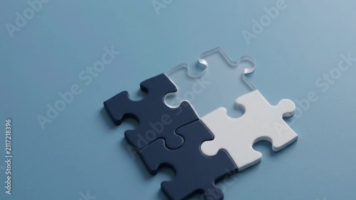 Different colored jigsaw puzzle pieces connected together representing business strategy team solution
