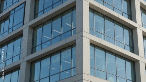 Modern corporate office building glass window facade architectural structure corner view

