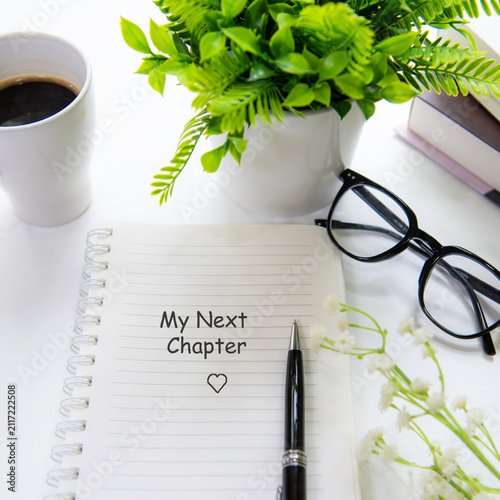 Notebook with my next chapter message inspiring new beginnings and future life planning.  Goal Life Wellness Concept.