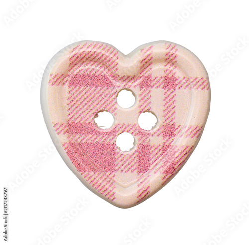 Heart shaped glittery pink and beige plaid sewing button isolated on white background