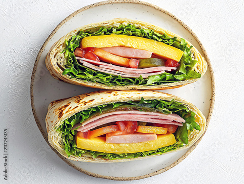 Delicious ham sandwich with cheese, lettuce, tomato and pickle on plate